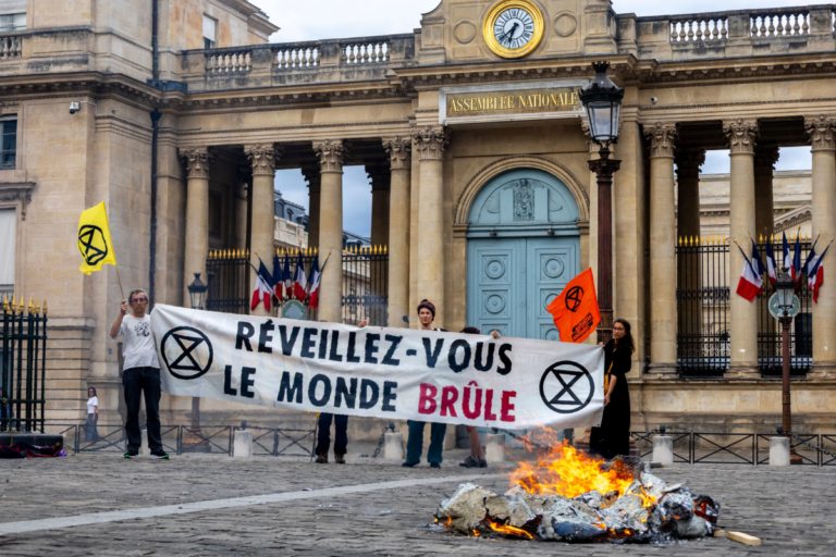 «Il faut politiser les canicules» : devant l’Assemblée, Extinction Rebellion dénonce l’inaction climatique et brûle une maquette de la Terre